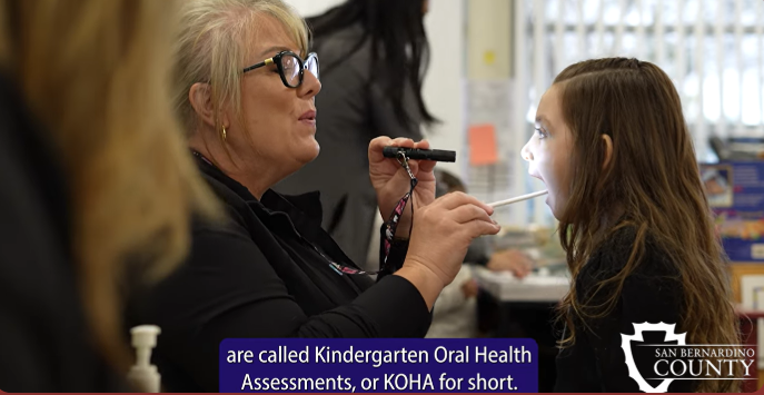 a kindergarten oral health assessment is taking place at a school