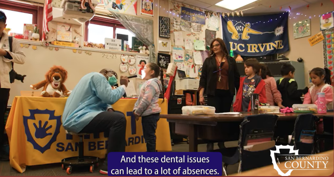 an oral health professional checking the oral health of kids